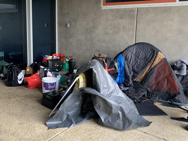 Three people have set up camp at the Frankston Yacht Club entrance.