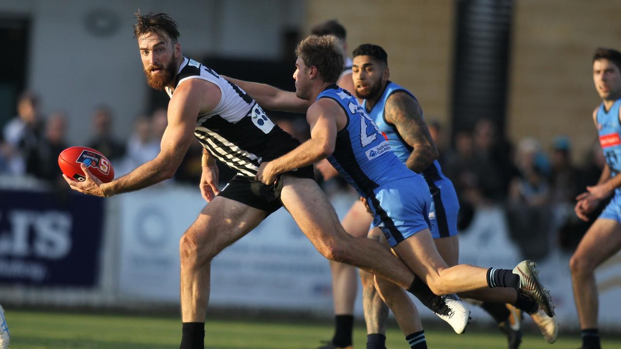 SANFL: Port Adelaide v Sturt at Alberton Oval. 8 June 2019. Port's Charlie Dixon looks to handball under pressure from Sturt's Sam Colquhoun late in the game.(AAP Image/Dean Martin)