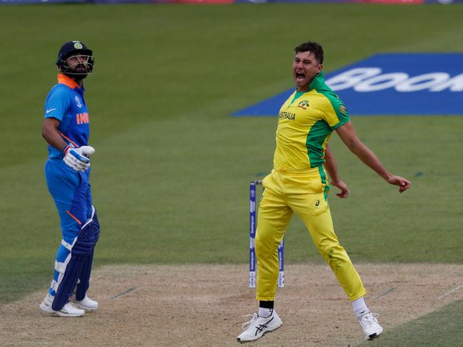 Marcus Stoinis celebrates after taking a catch off his own bowling to dismiss India’s Mahendra Singh Dhoni. Picture: AFP