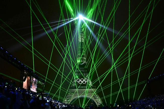 Lights illuminate the Eiffel Tower during the opening ceremony of the Paris 2024 Olympic Games in Paris on July 26, 2024. (Photo by Loic VENANCE / POOL / AFP)