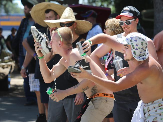 Canberra boys L-R: Mark Featherstone (21) and Brock Fantich (19yrs-wearing cap) drink beer from their shoes (known as a shoey) at the annual Street Machine Summernats Car Festival. Picture: Gary Ramage/ News Corp Australia
