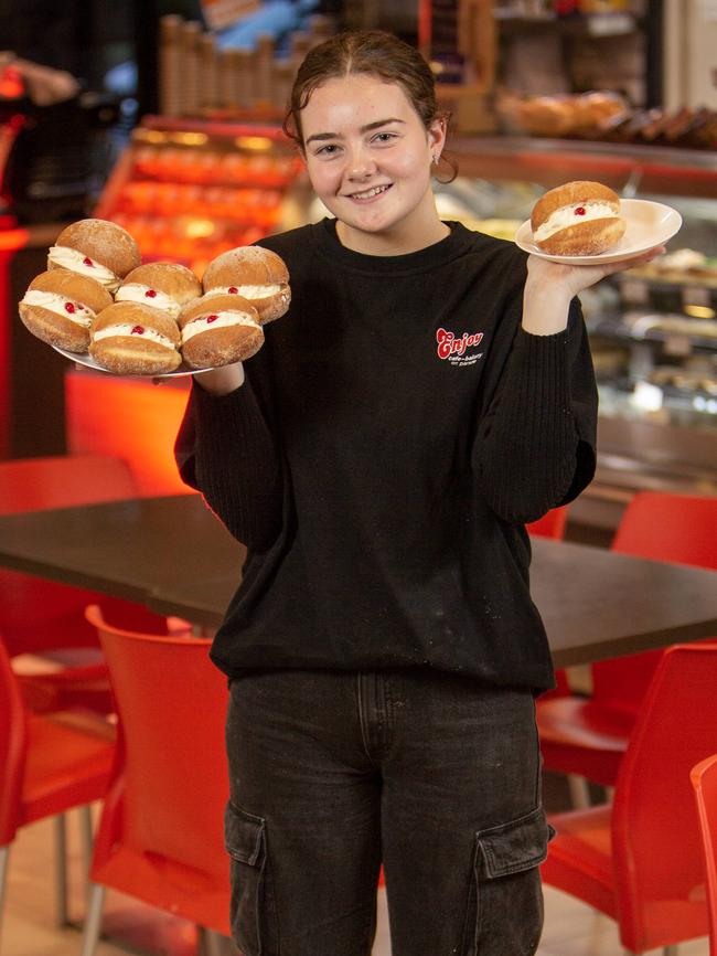 Norwood Bakery Enjoy Cafe worker Stella Glynn one of the beloved buns which deserve better branding in South Australia. Picture: Emma Brasier