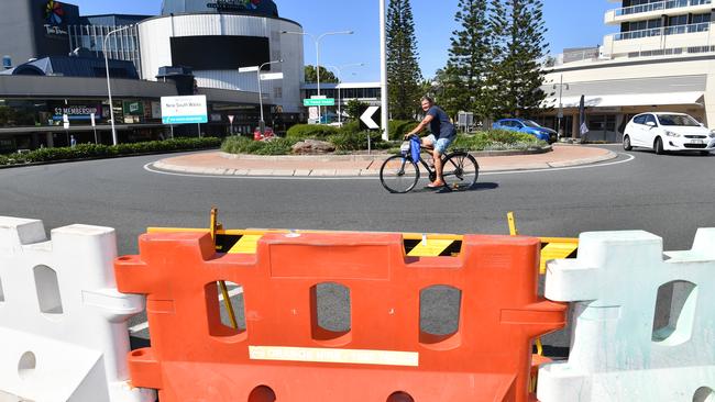 A cyclist riding past a barrier across the Queensland and New South Wales border. (AAP Image/Darren England)