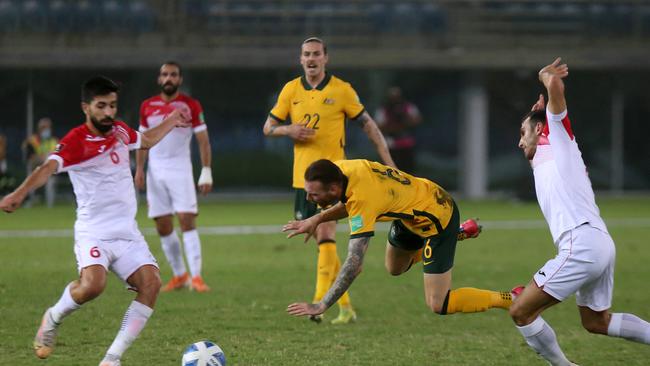 Socceroos attacker Martin Boyle takes a tumble against Jordan. Picture: Yasser Al-Zayyat / AFP