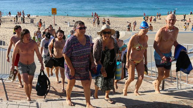 Beachgoers are forced to leave Coogee Beach on Anzac Day in Sydney. Picture: Gaye Gerard