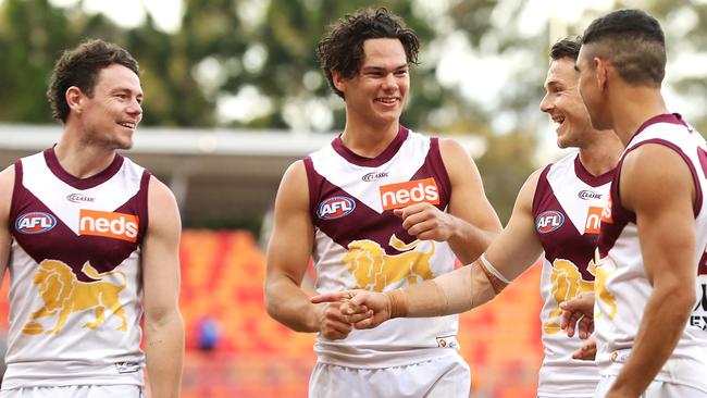 Lachie Neale, Cam Rayner, Lincoln McCarthy and Charlie Cameron of the Lions share a laugh as they leave the field after victory. Picture: Getty Images