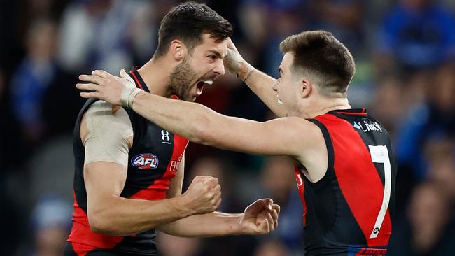 MELBOURNE, AUSTRALIA - AUGUST 12: Kyle Langford (left) and Zach Merrett of the Bombers celebrate during the 2023 AFL Round 22 match between the North Melbourne Kangaroos and the Essendon Bombers at Marvel Stadium on August 12, 2023 in Melbourne, Australia. (Photo by Michael Willson/AFL Photos via Getty Images)