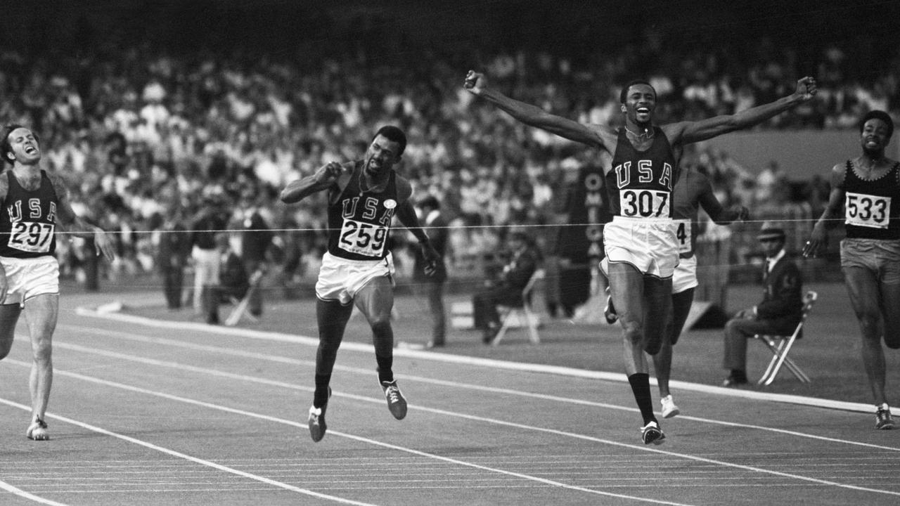 Tommie Smith, US, throws his arms up in victory as he hits the tape to win a gold medal in the men's 1972 Olympic 200m. Picture: supplied