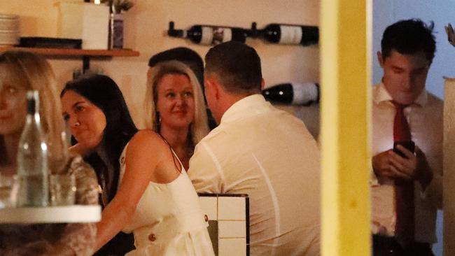 Sam Burgess (back to camera) chats to Jana Hocking as his lawyer Bryan Wrench is on his phone on the right. Picture: Damian Shaw