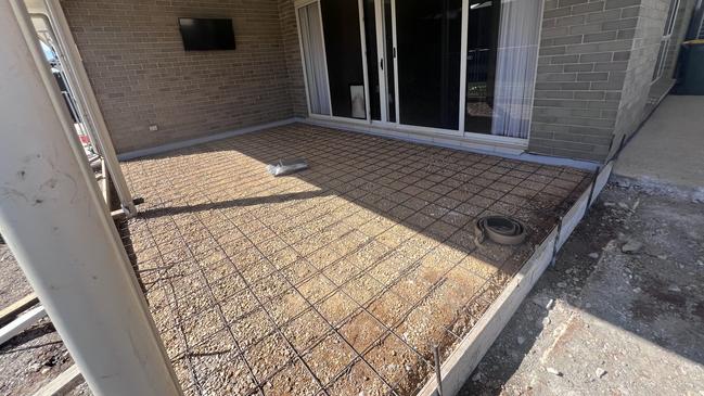 Kelly Bunker and Gary Prause hired Adelaide Exposed Concrete to concrete their backyard, but the job was never finished. Picture: Supplied