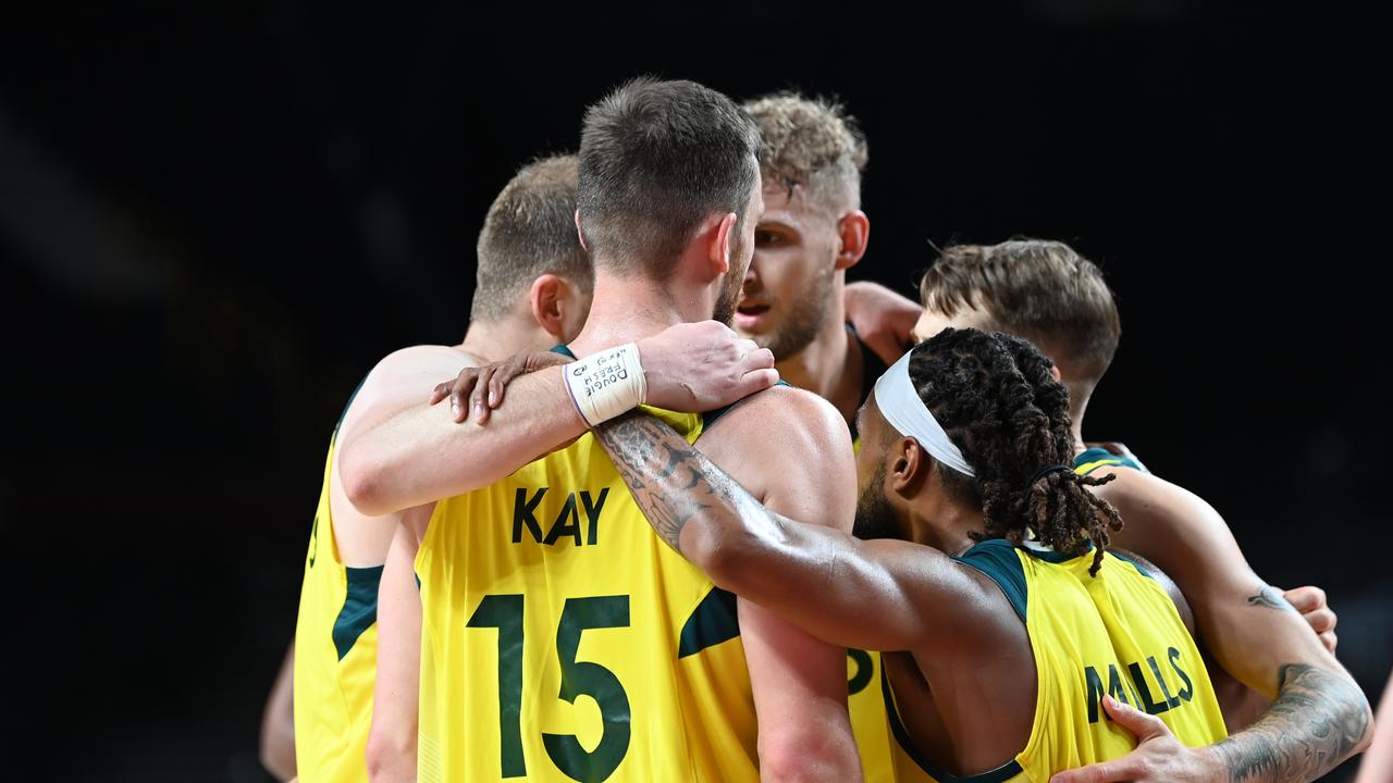 31 July 2021, Japan, Saitama: Basketball: Olympics, Australia - Germany, Preliminary Round, Group B, Matchday 3 at Saitama Super Arena. Australia's players hug each other during the match. Photo: Swen PfÃ¶rtner/dpa (Photo by Swen PfÃ¶rtner/picture alliance via Getty Images)