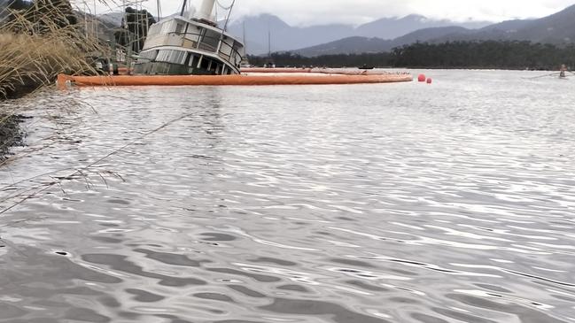 The Cartela has had a boom placed around it but some rowing spectators believe oil on the Huon River at Franklin could be from the ferry. Picture: Supplied.