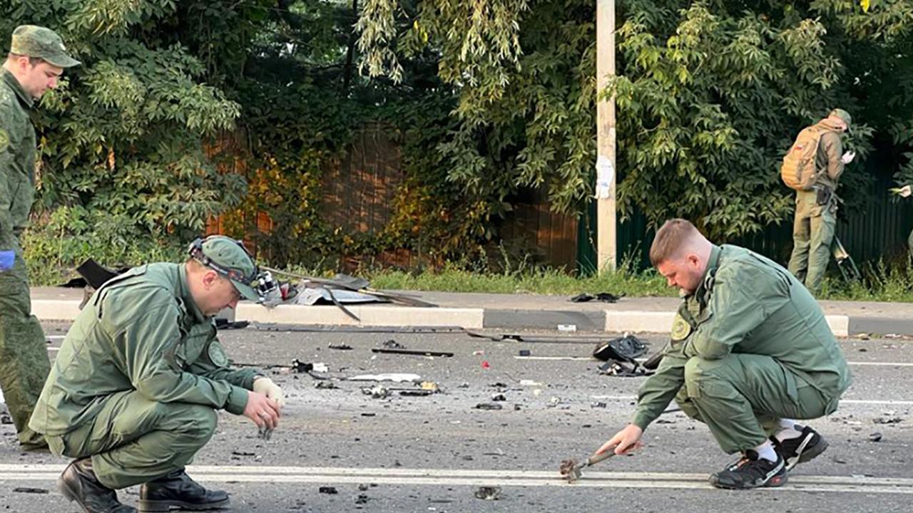 Investigators collect evidence from after the explosion which killed Darya Dugina. Picture: Handout/Investigative Committee of Russia/AFP