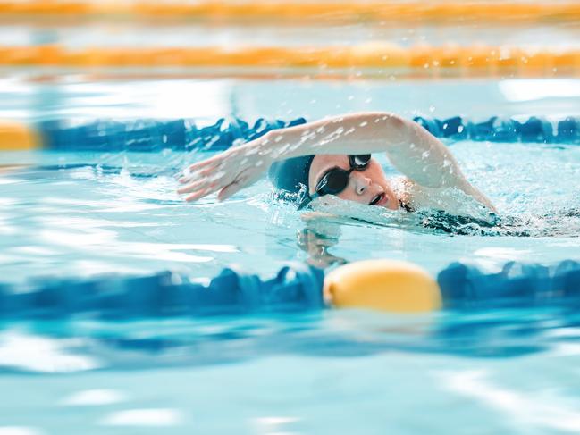 Woman, pool and swimming in sports fitness, exercise or training in water olympics or athletics. Female person, athlete or professional swimmer in competition, race or marathon in workout practice