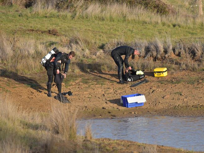 Divers prepare to search the dam. Picture: Ian Wilson