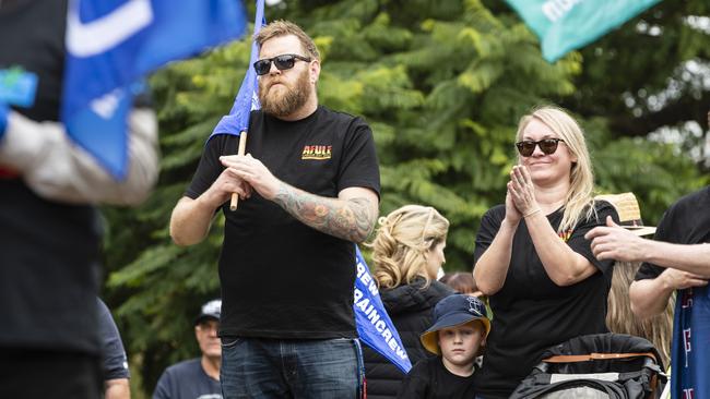 AFULE secretary Michael McKitrick with Arkin McKitrick and Natalie Bower listen to speakers at the Toowoomba Labour Day march, Saturday, April 29, 2023. Picture: Kevin Farmer