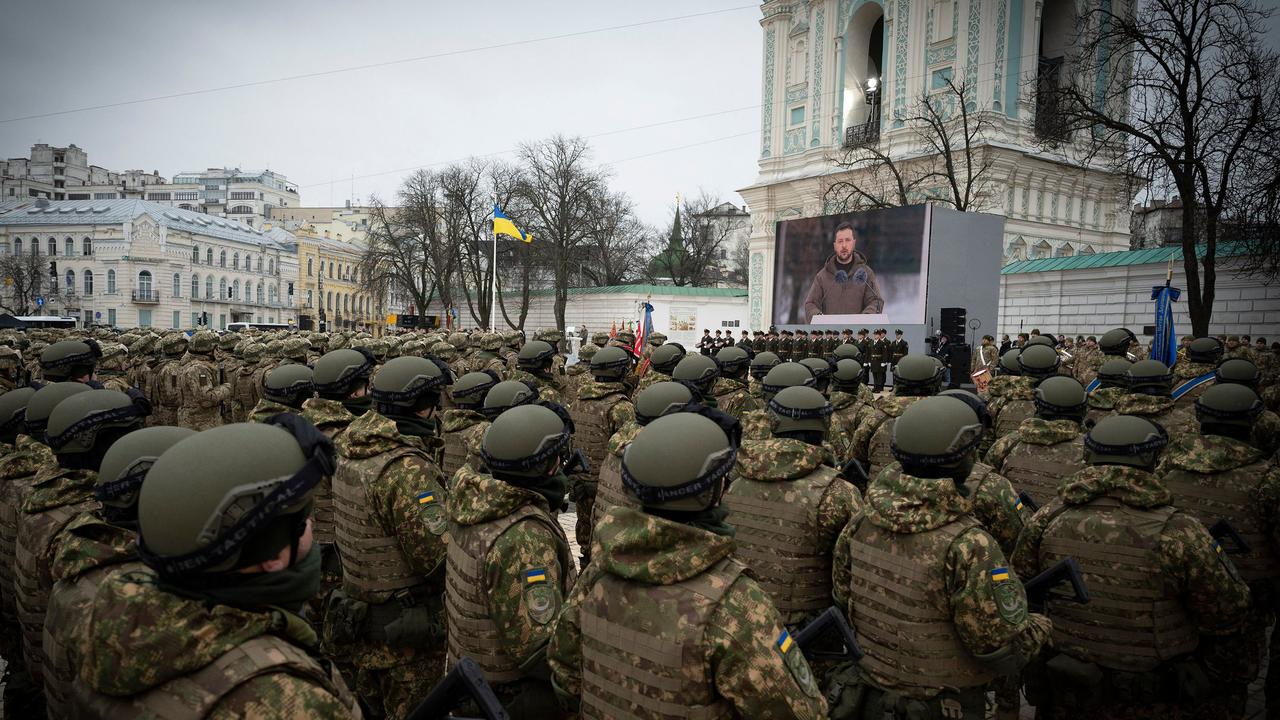 Ukrainian troops watch Zelenskyy shown on a screen at St Sophia Square in Kyiv. Picture: AFP