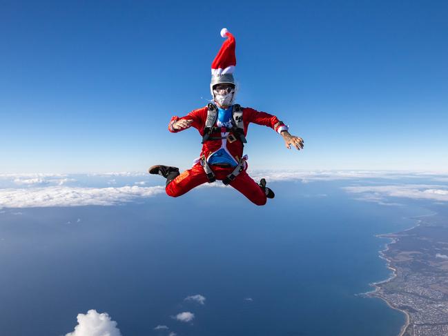 EMARGOED UNTIL 24.12.24Santa from the Great Ocean Road Skydive Australia team jumps into action over our coastline. Picture:  Logan Morris**NOT FOR PHOTOSALES**(Must mention Skydive Australia in ALL captions)