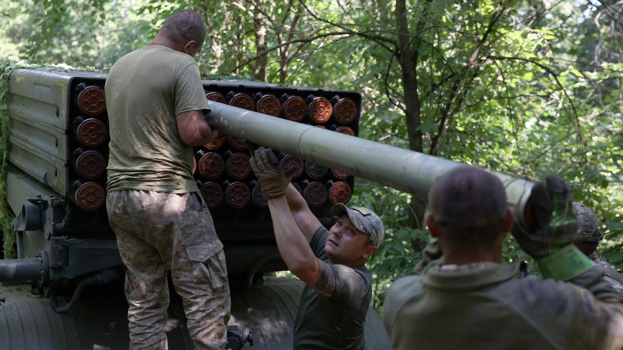 Ukrainian artillerymen load missiles onto a rocket launcher near Bakhmut. Picture: AFP