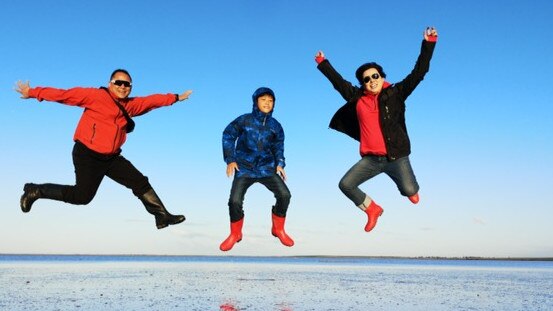 Chinese tourists take a jump at Lake Tyrrell, near Sea Lake, Victoria.