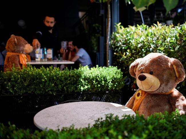 Some cafes use oversized teddies to keep customers apart. Picture: Armend Nimani/AFP