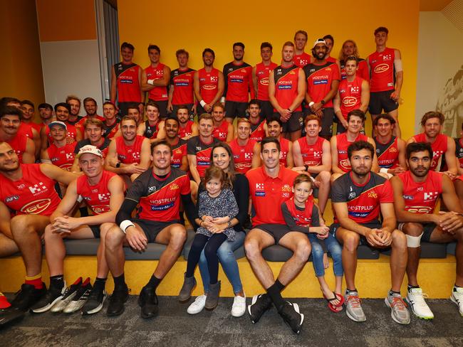 Michael Rischitelli poses with wife Jo and children Lia and Kai with the Suns team after announcing his retirement during a Gold Coast Suns AFL press conference on August 20, 2019 in Gold Coast, Australia. (Photo by Chris Hyde/AFL Photos/via Getty Images)