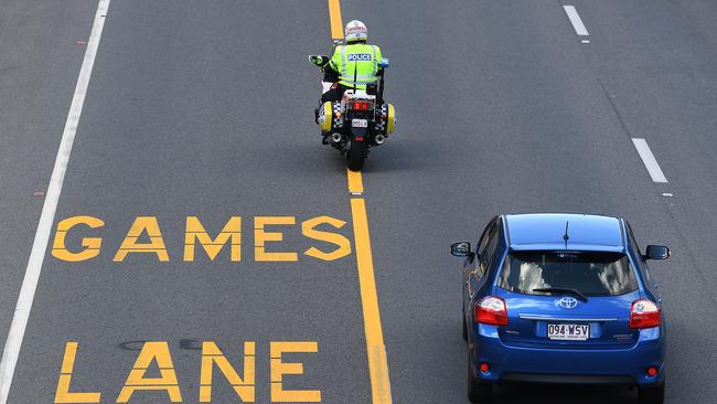 A police officer patrols near a designated Commonwealth Games Lane (AAP Image/Dave Hunt)