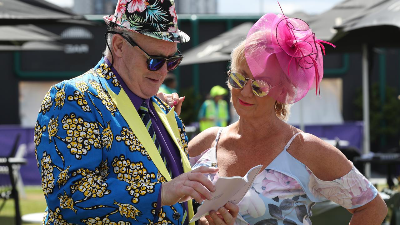 Racegoers check out the form. Picture: AAP