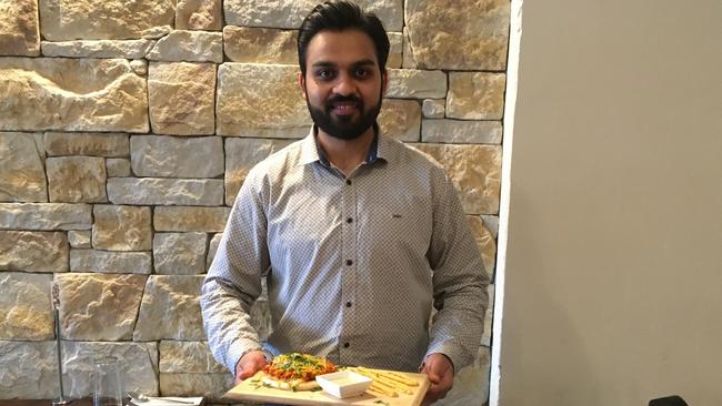 Indigo Delight co-owner Aman Singh with the butter chicken slider