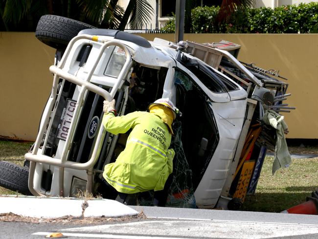 Queensland Fire and Rescue personnel attend a car crash on corner of Greenslopes and Pease St at Edge Hill PICTURE: ANNA ROGERS