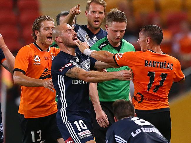 James Troisi of Melbourne (second left) has an altercation with Eric Bautheac of the Roar (right) before Bautheac was sent off, during the Round 8 A-League match between Brisbane Roar FC and Melbourne Victory at Suncorp Stadium in Brisbane, Friday, December 14, 2018. (AAP Image/Jono Searle) NO ARCHIVING, EDITORIAL USE ONLY