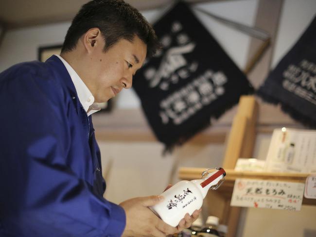 Michihiro Kono with a bottle of the miracle soy sauce.