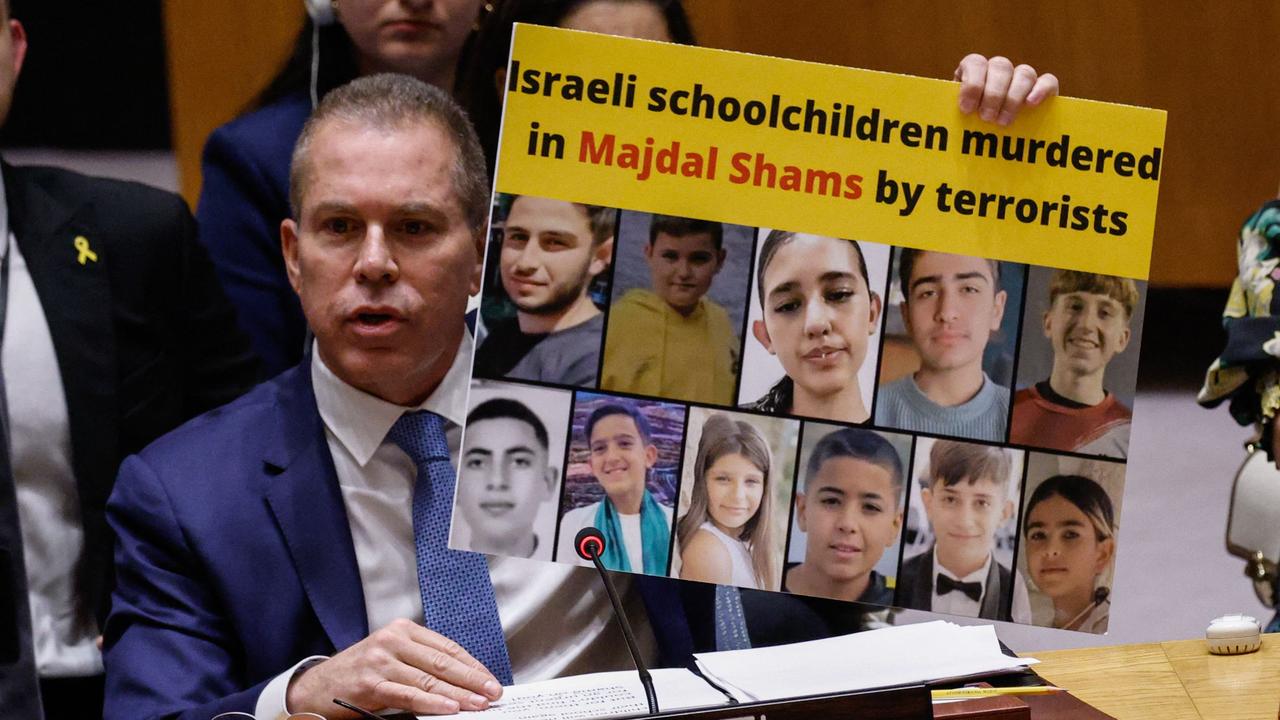 Israel's Ambassador to the United Nations Gilad Erdan holds up a poster of murdered schoolchildren as he speaks during a UN Security Council meeting on the situation in the Middle East. Picture: Kena Betancur/AFP