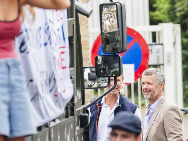 King Frederik X looks on as the students pile in to their decorated van. Photo: Getty Images.