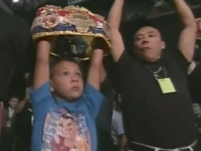 A nine-year-old Tim Tszyu holding his the Ring Magazine belt, with granddad Boris holding the WBC title ahead of the Jesse James Leija fight in 2003. Picture: YouTube.