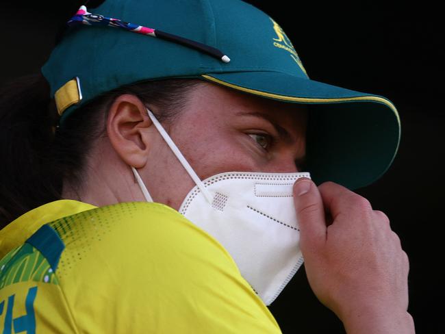 Australia's Tahlia McGrath stands on the team balcony wearing a face mask during the women's Twenty20 Cricket gold medal match between India and Australia on day ten of the Commonwealth Games at Edgbaston in Birmingham, central England, on August 7, 2022. (Photo by Darren Staples / AFP)