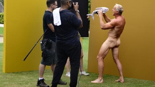 Greg Norman hams it up with a fluffy Great White Shark toy for an ESPN shoot. Picture: ESPN