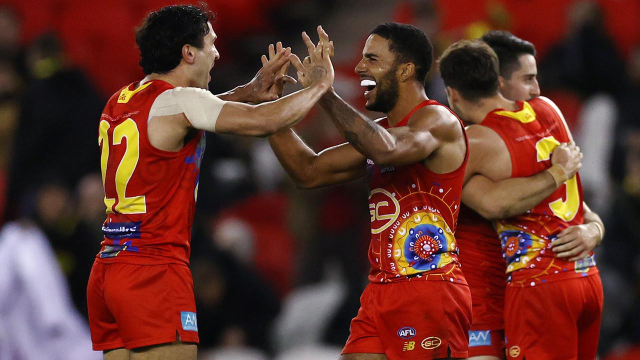 Gold Coast co-captain Touk Miller, pictured right celebrating with Izak Rankine, is desperate for his teammate to stay. Picture: Michael Klein