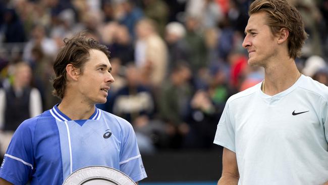 Asutralia's Alex de Minaur (L) celebrates with the trophy after winning against US' Sebastien Korda after their men's singles final match of Rosmalen Grass Court Championships tennis tournament in Rosmalen, near Hertogenbosch, on June 16, 2024. (Photo by Sander Koning / ANP / AFP) / Netherlands OUT