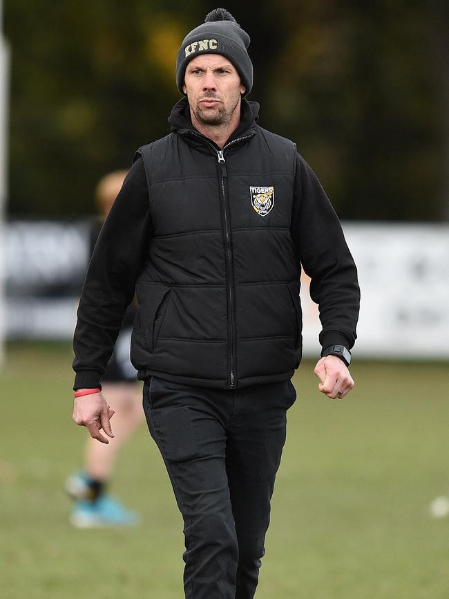 Kyneton coach Luke Beattie patrols the ground at a break in play. 