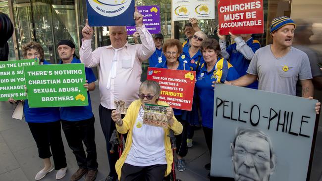 Protesters outside the County Court where Cardinal George Pell had his bail revoked this week. Picture: AP/Andy Brownbill