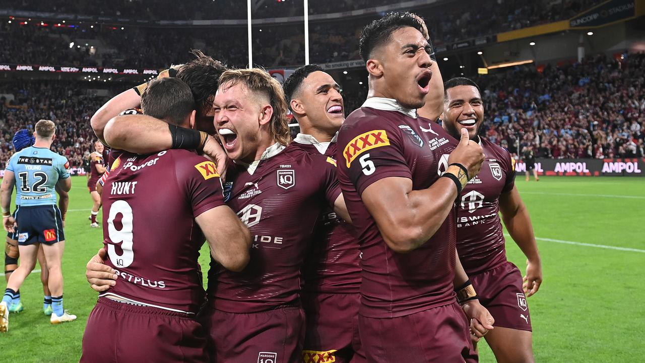 Murray Taulagi, Reuben Cotter and Valetine Holmes of the Maroons celebrate victory. Picture: Getty Images