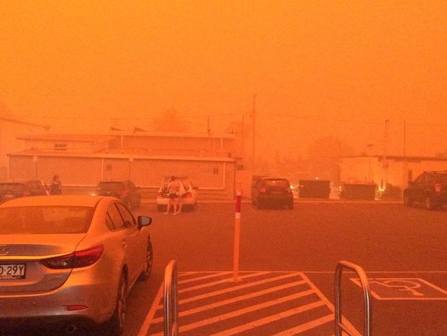 Batehaven’s IGA supermarket car park during the 2019 bushfires. The family who ran it kept it open during the bushfire crisis even after losing their home. Picture: Jonathan Ng