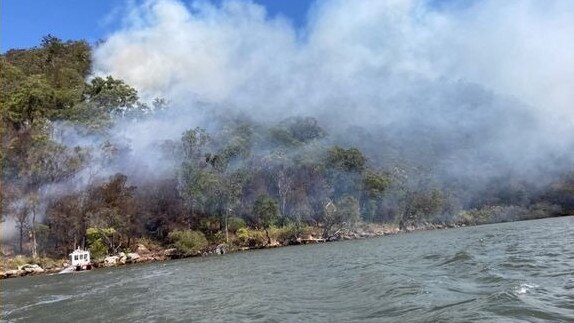 A fire is burning in remote bushland near Sunny Corner, 8km north of Berowra. Access to this fire is by water only, with firefighters using specialised boats and helicopters to contain this fire. Picture: RFS NSW