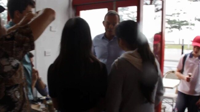 Students ambush Tony Abbott over climate change in a cafe in Manly.