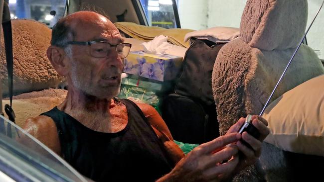 Retiree butcher David Willcox adjusts the antenna of his transistor radio before going to sleep in his Nissan Tilda parked in Coffs Central Shopping Centre multistorey car park. Picture: Toby Zerna