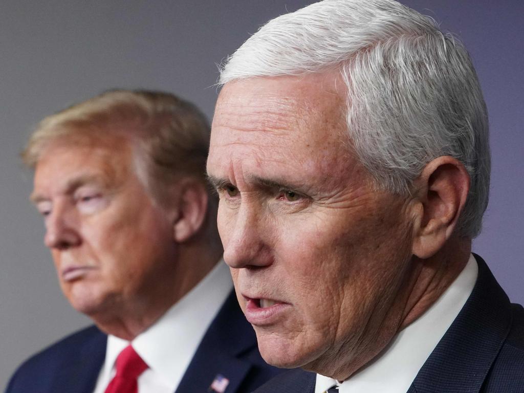 US President Donald Trump listens to US Vice President Mike Pence speak during a COVID briefing last year. Picture: AFP