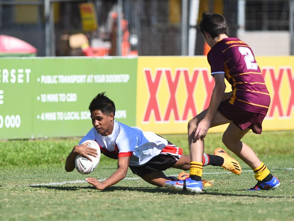 Boys Rugby League State Championship held at Northern Division, Brothers Leagues ground, Townsville. Northwest (maroon) v Wide Bay (white) 14-15 years. Brayden Watcho of Murgon SHS scores a try.