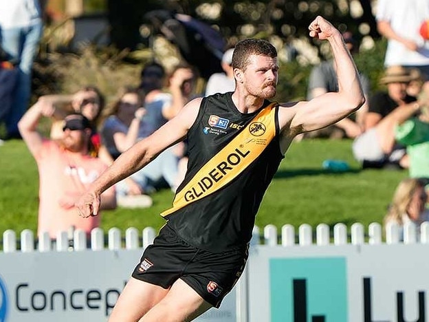 Nic Minchin celebrates a goal while playing for Glenelg,