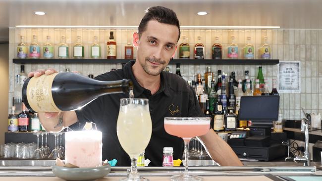 Sails restaurant and bar is now open on Trinity Inlet, in the location of the former Mondos restaurant. Sails bar supervisor Mirko Mauri mixes up some delicious cocktails for thirsty diners. Picture: Brendan Radke